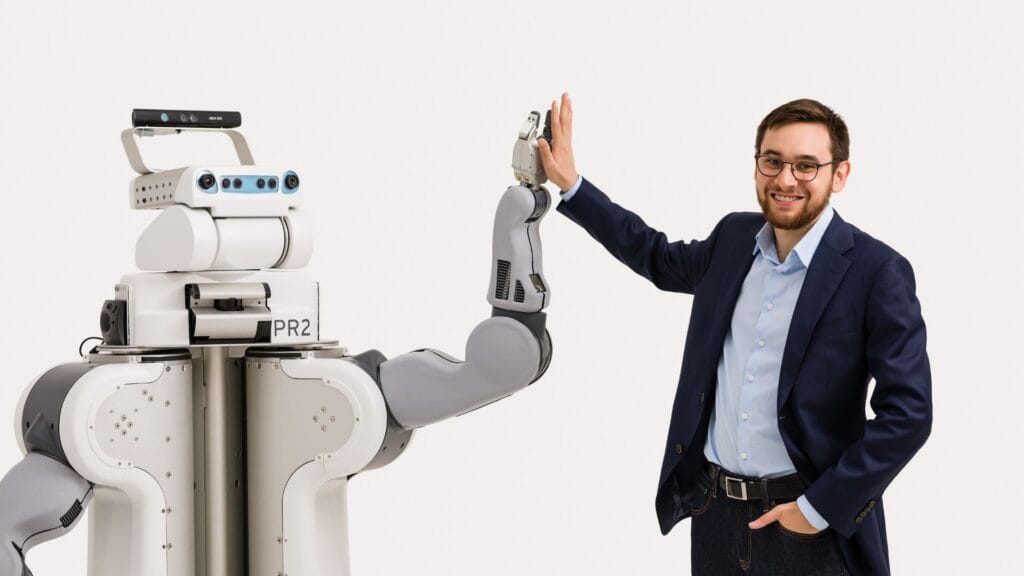 Tom Williams high fiving a robot