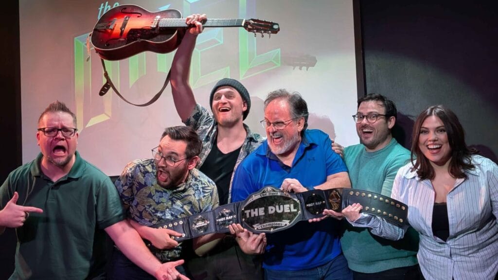 Minor adjustments improv group celebrating their risecomedy win